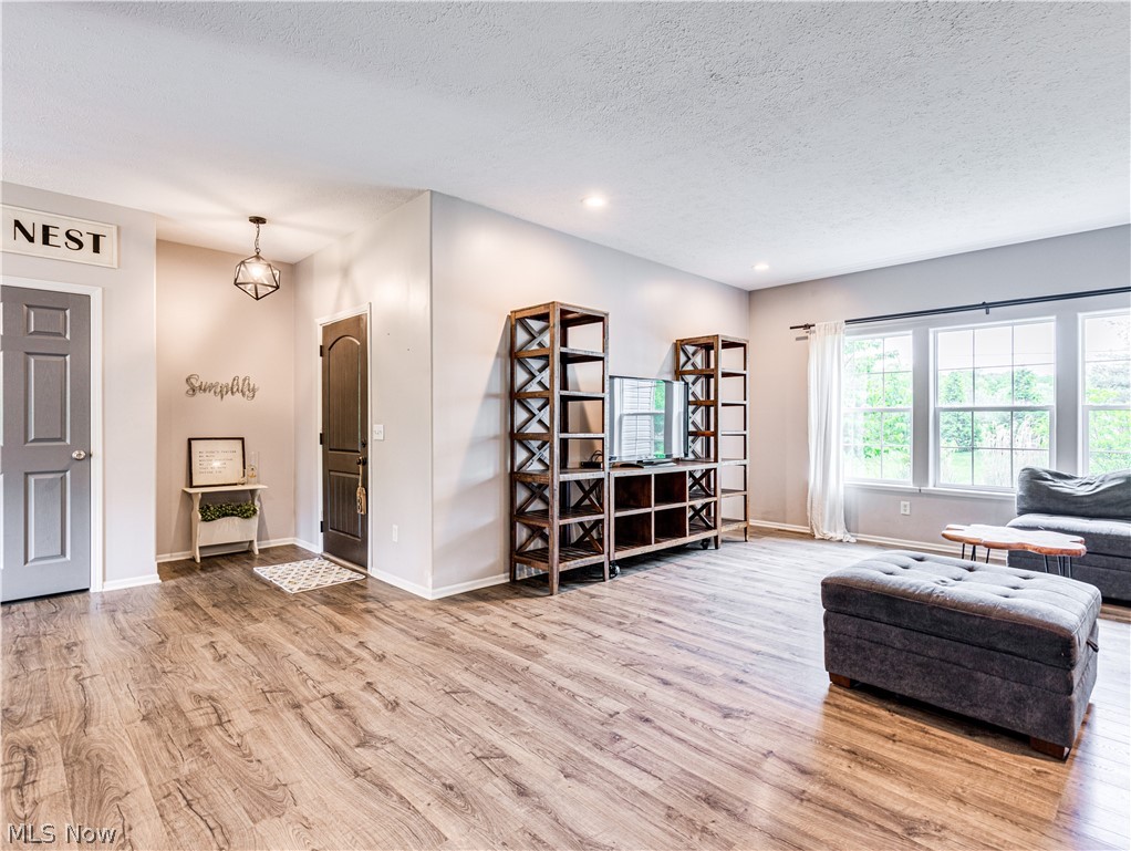 6573 Boneta Road Medina, OH 44256 - Photo 6 of 38 Living room featuring a textured ceiling and hardwood / wood-style floors