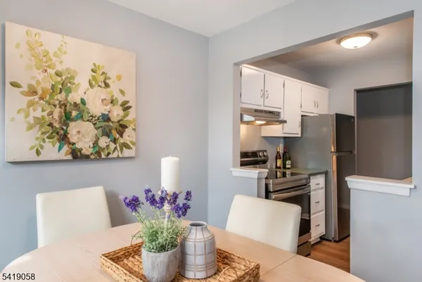 a kitchen with stainless steel appliances granite countertop a refrigerator and a stove