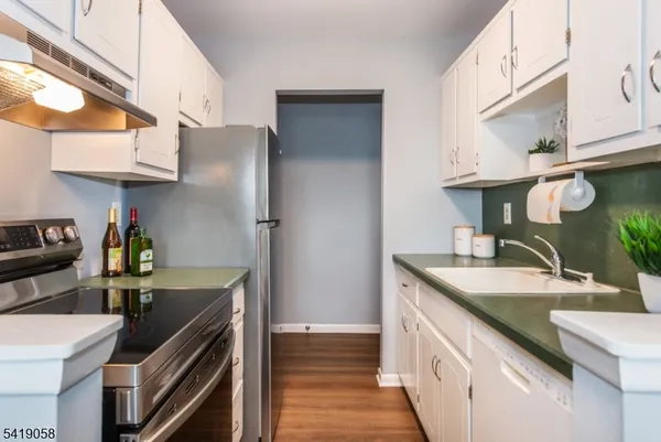 a kitchen with a sink stove and cabinets