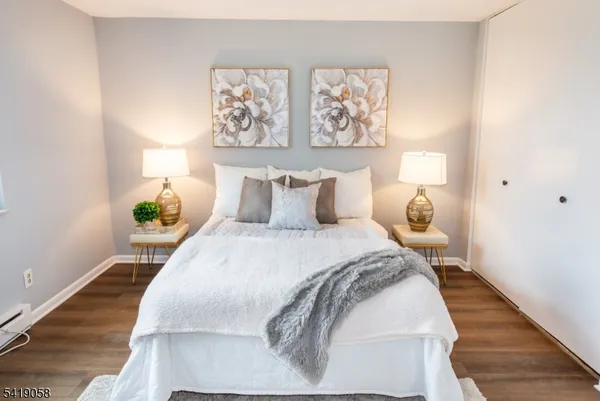 a bedroom with a bed and painting on the wall