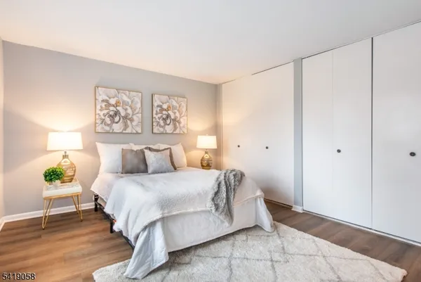 a bedroom with a bed and a painting on the wall