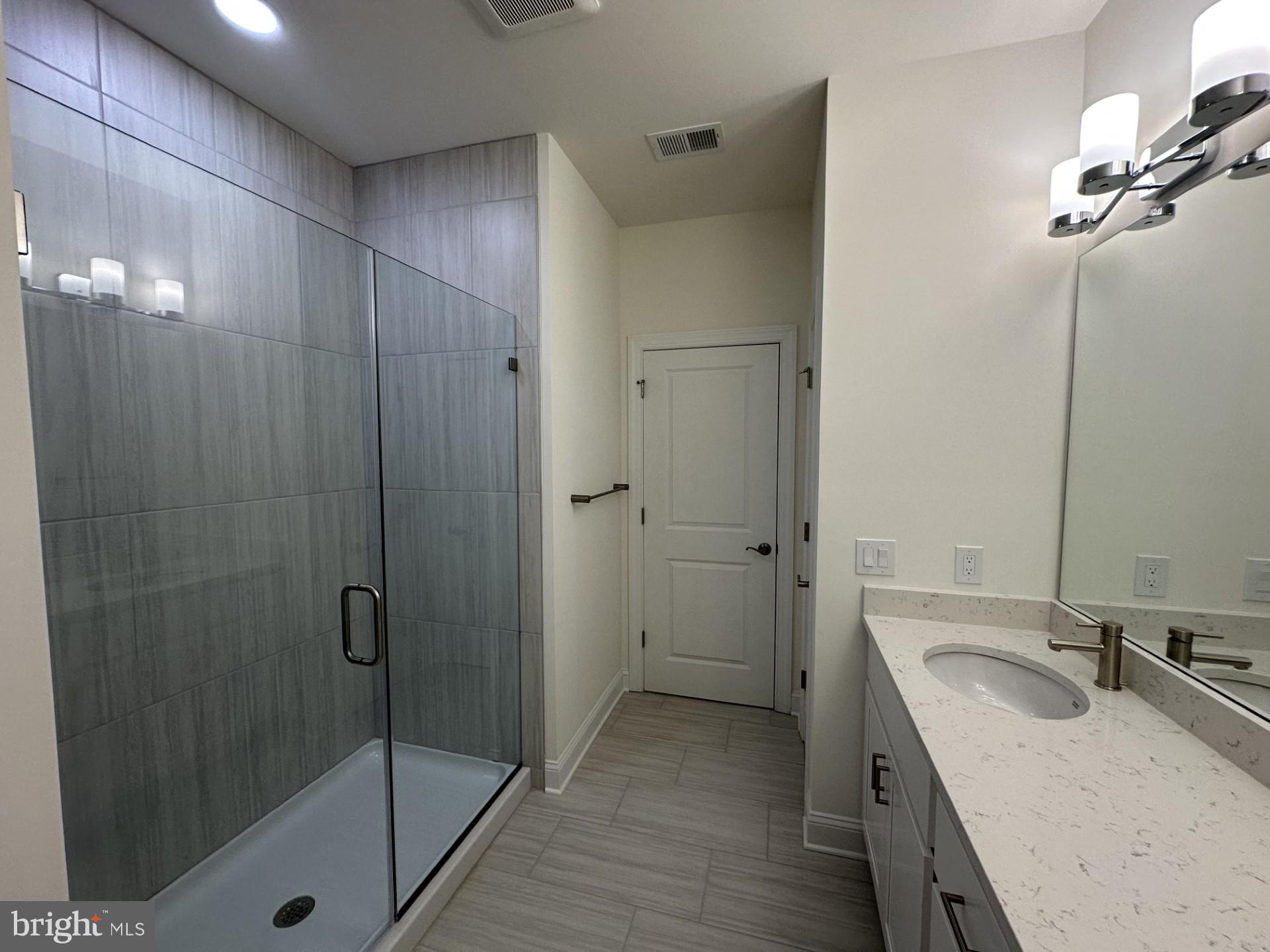 63 Kay Chiarello Way Hamilton, NJ 08690 - Photo 11 of 31 a bathroom with a sink and mirror with shower