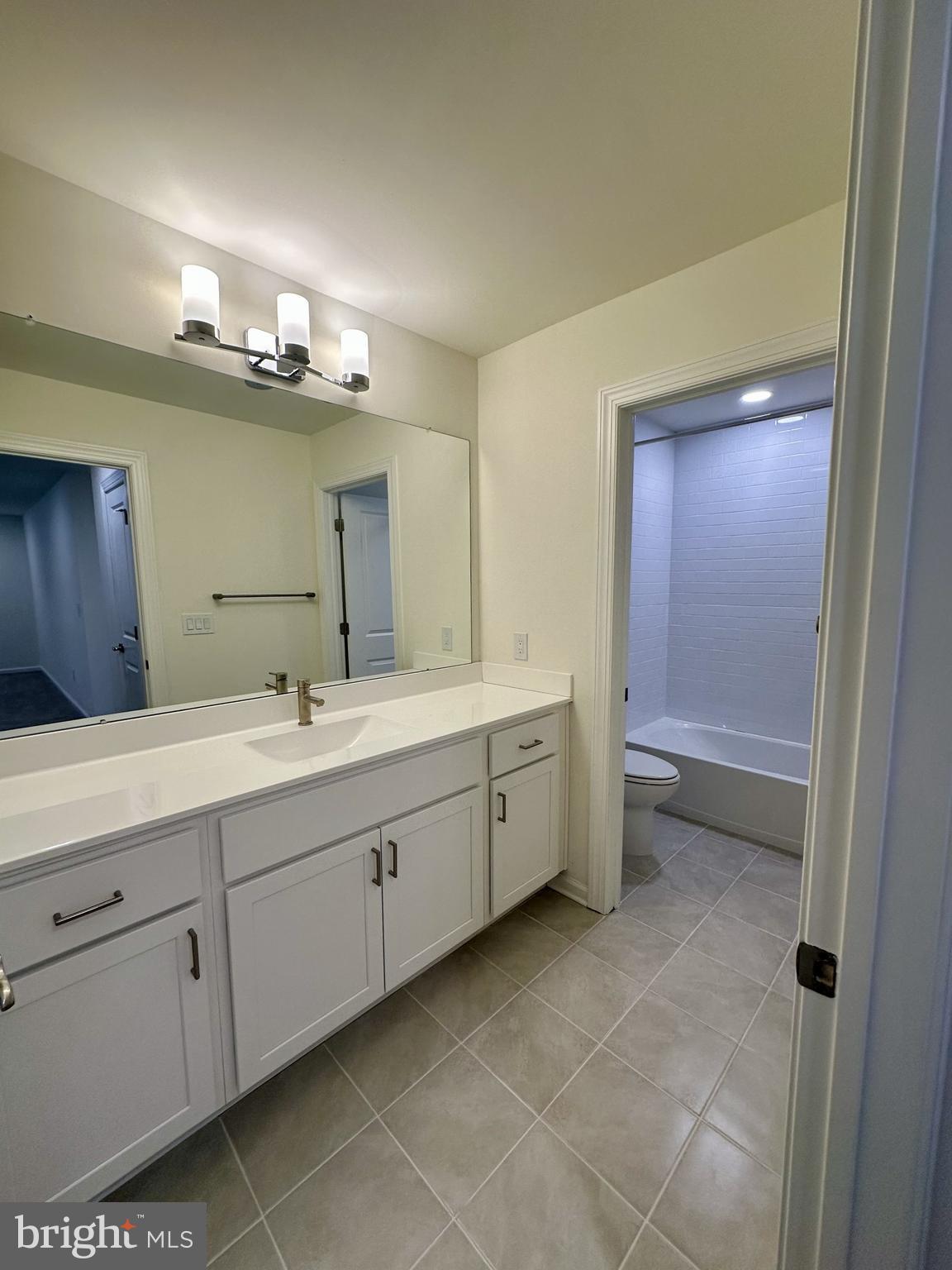 63 Kay Chiarello Way Hamilton, NJ 08690 - Photo 13 of 31 a spacious bathroom with a double vanity sink a mirror and a bathtub