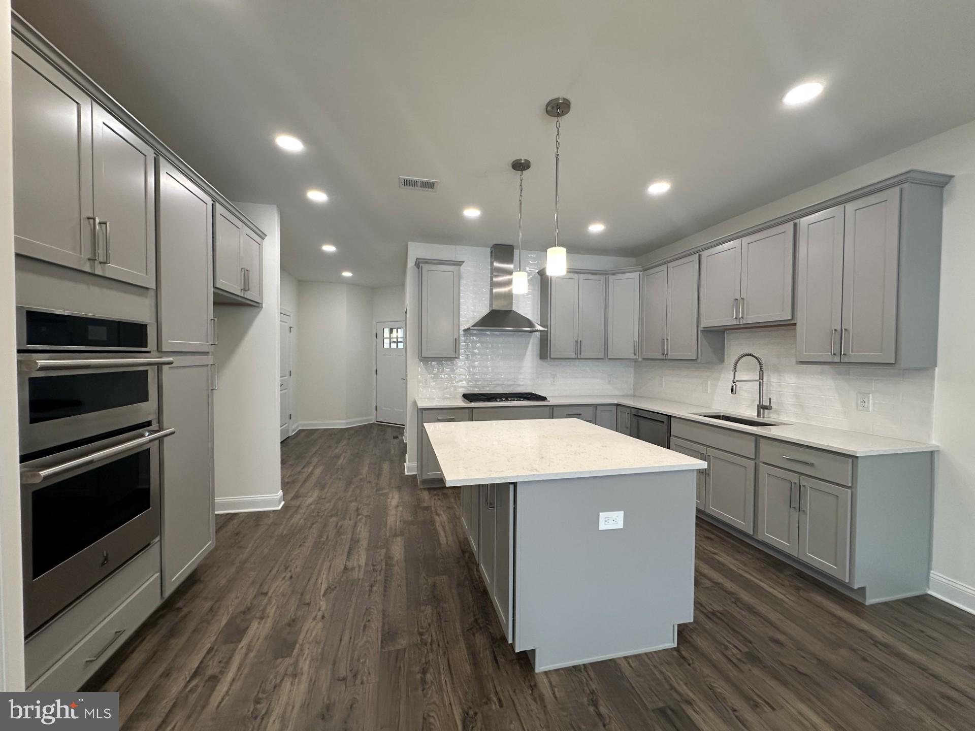 63 Kay Chiarello Way Hamilton, NJ 08690 - Photo 2 of 31 a kitchen with kitchen island a sink wooden floor and stainless steel appliances