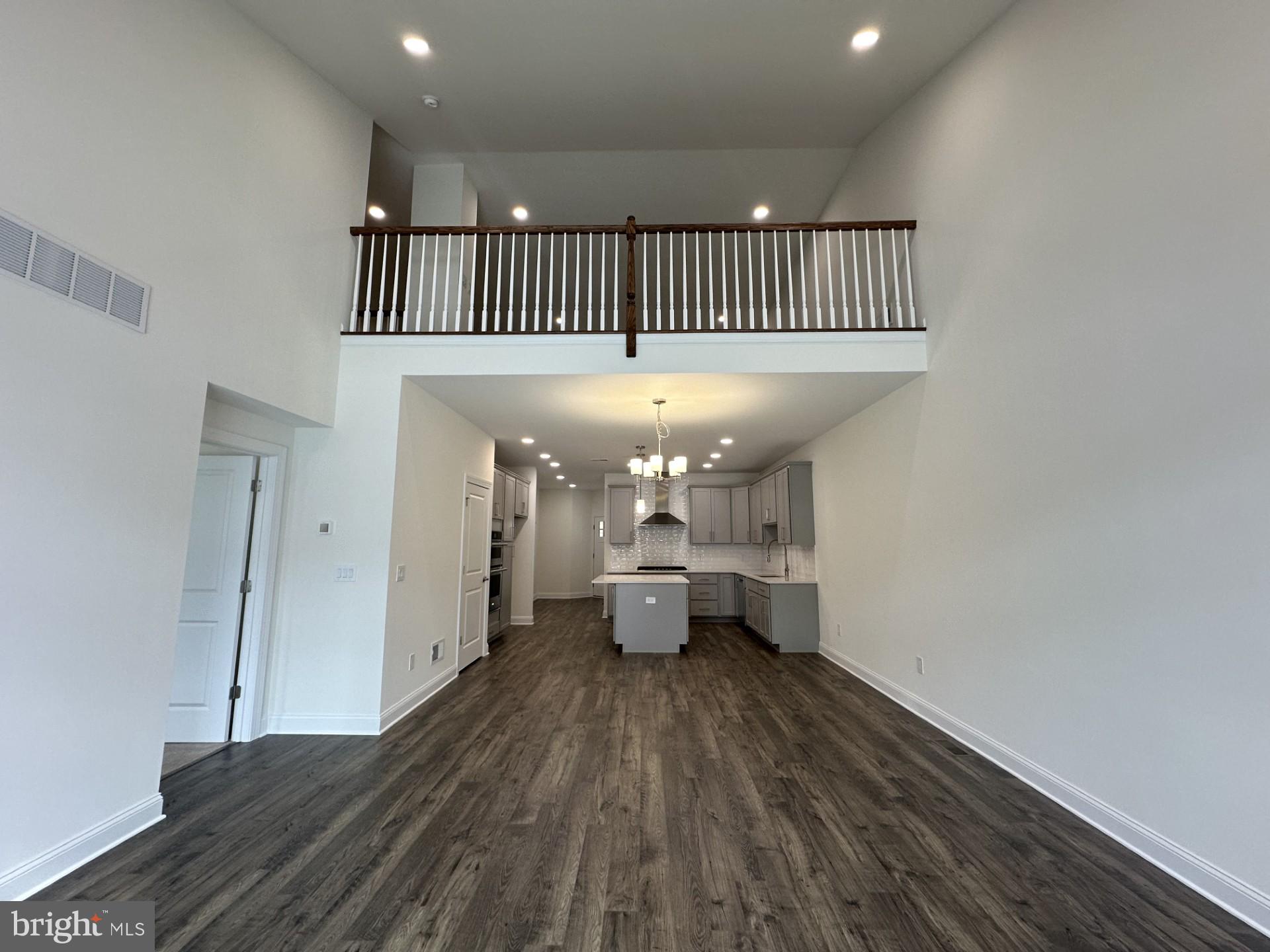 63 Kay Chiarello Way Hamilton, NJ 08690 - Photo 6 of 31 a view of a room with wooden floor a ceiling fan and windows