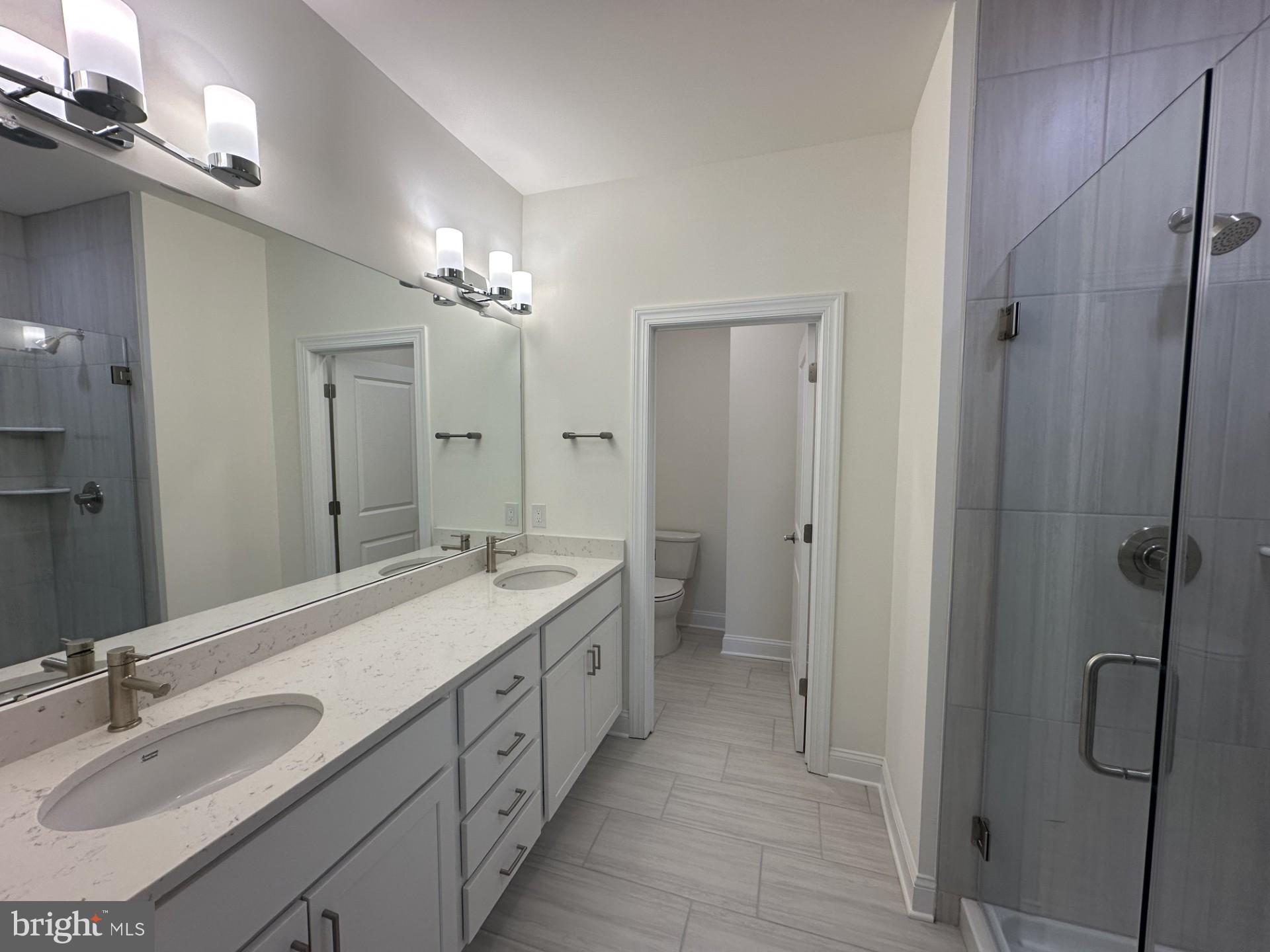 63 Kay Chiarello Way Hamilton, NJ 08690 - Photo 10 of 31 a spacious bathroom with a double vanity sink mirror and double