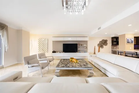 a living room with furniture fireplace and a large window