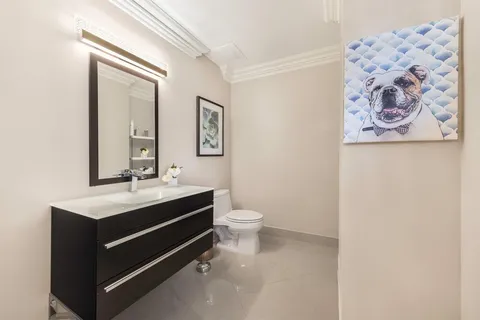 a living room with furniture and a view of kitchen