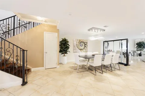 a kitchen with stainless steel appliances kitchen island granite countertop a refrigerator and a stove top oven