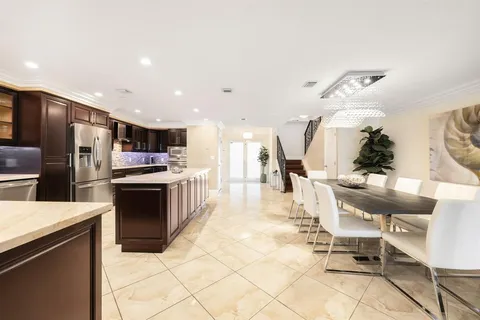 a kitchen with stainless steel appliances kitchen island granite countertop a sink and cabinets