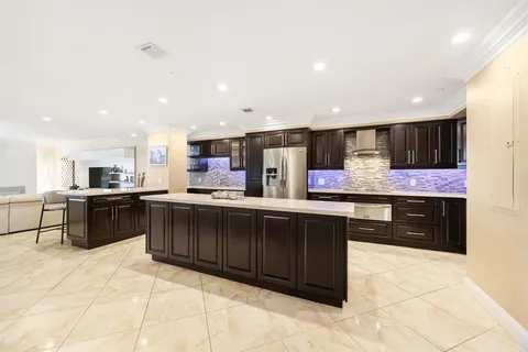 a kitchen with granite countertop a cabinets and stainless steel appliances