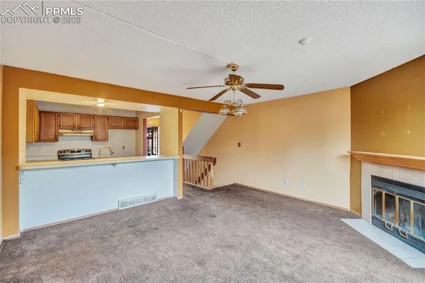 a view of a kitchen with a sink and refrigerator