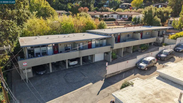 an aerial view of a house with a yard balcony