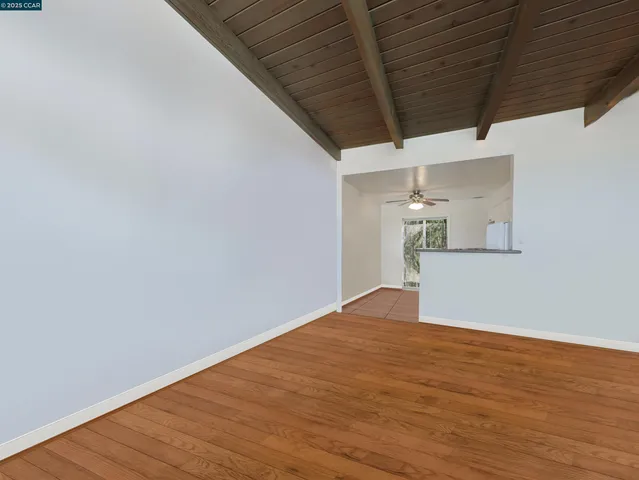 a view of big room with wooden wall and windows