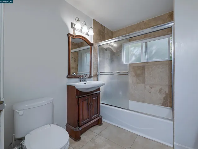 a kitchen with kitchen island a counter space a sink a window and stainless steel appliances
