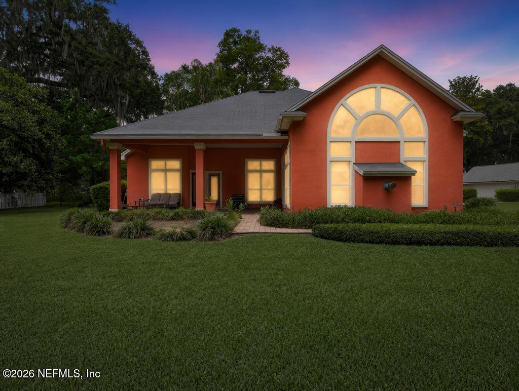1483 Bridgette Way Fleming Island, FL 32003 - Photo 9 of 63 a front view of a house with a garden