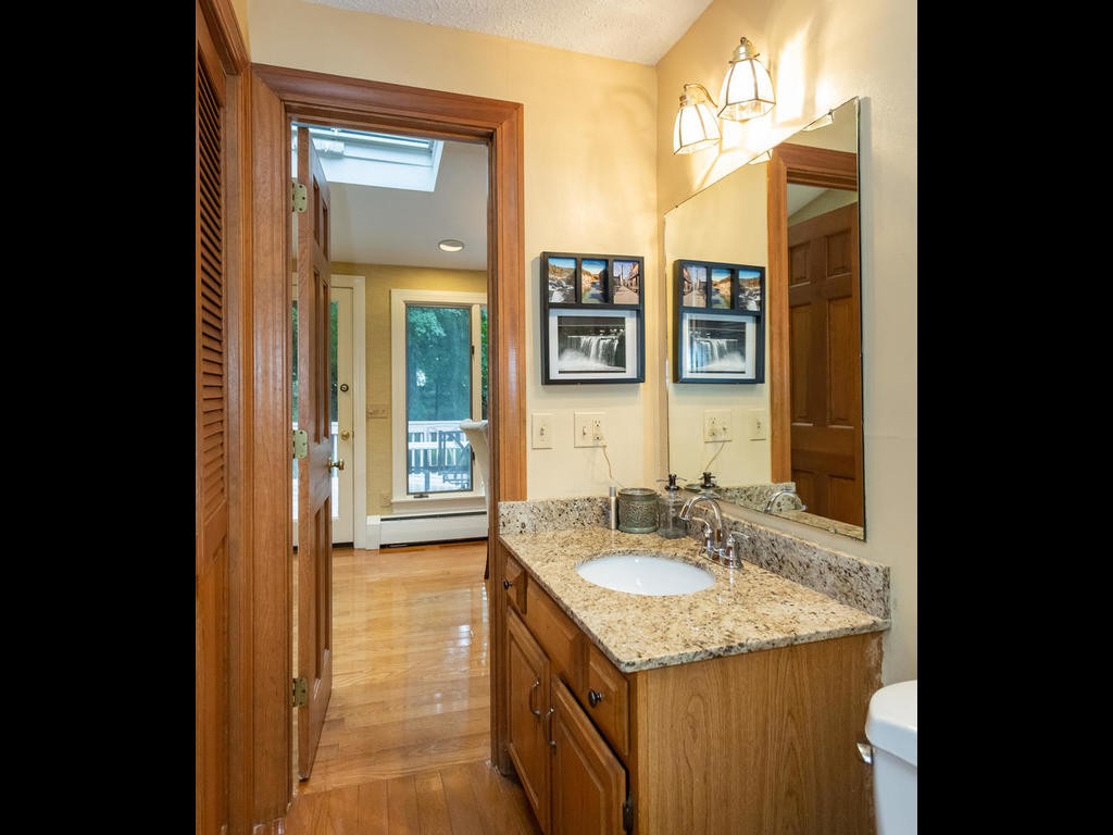 28 Ardsley Road Longmeadow, MA 01106 - Photo 13 of 30 a bathroom with a granite countertop sink a mirror and a shower