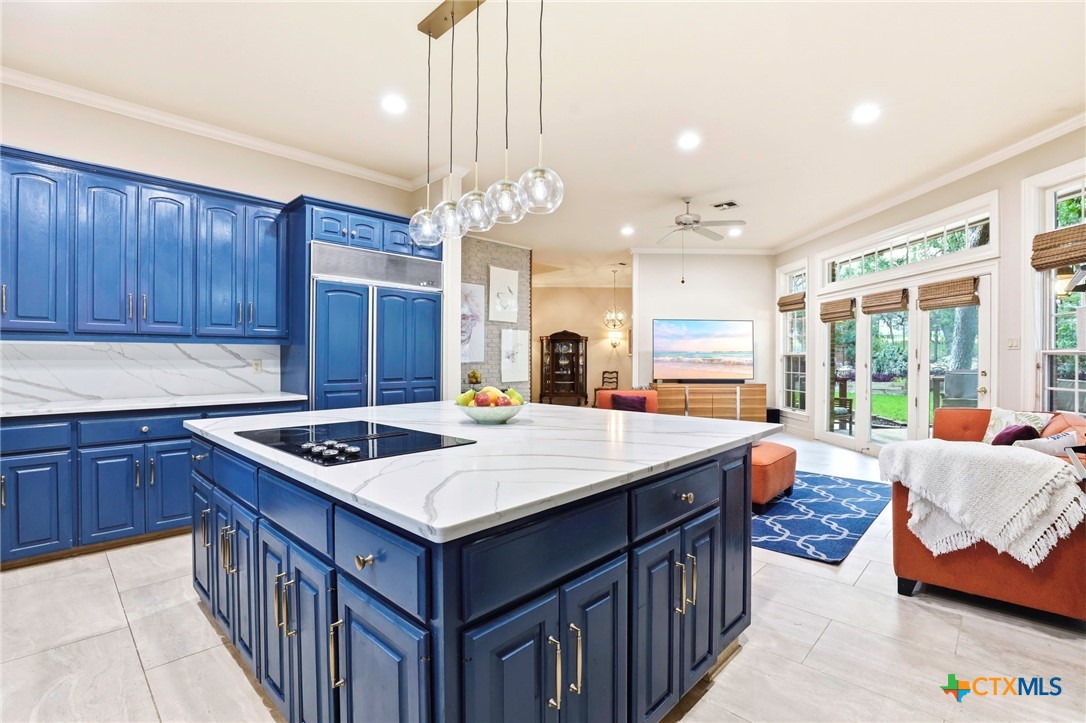 21759 Forest Waters Circle Garden Ridge, TX 78266 - Photo 12 of 30 a kitchen that has a sink a stove and a table in it