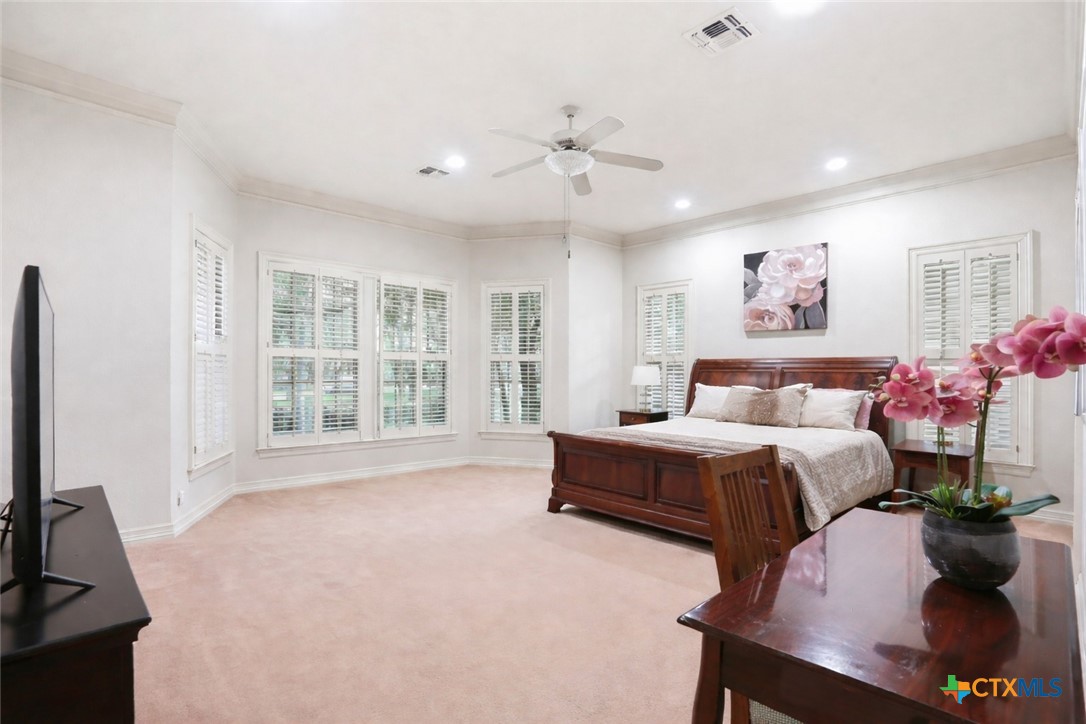 21759 Forest Waters Circle Garden Ridge, TX 78266 - Photo 16 of 30 a spacious bedroom with a bed and a flat screen tv