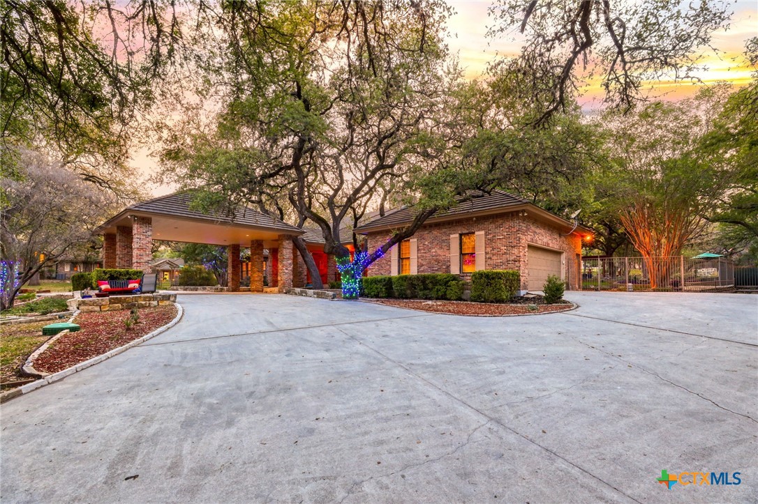 21759 Forest Waters Circle Garden Ridge, TX 78266 - Photo 23 of 30 a front view of a house with a yard and garage