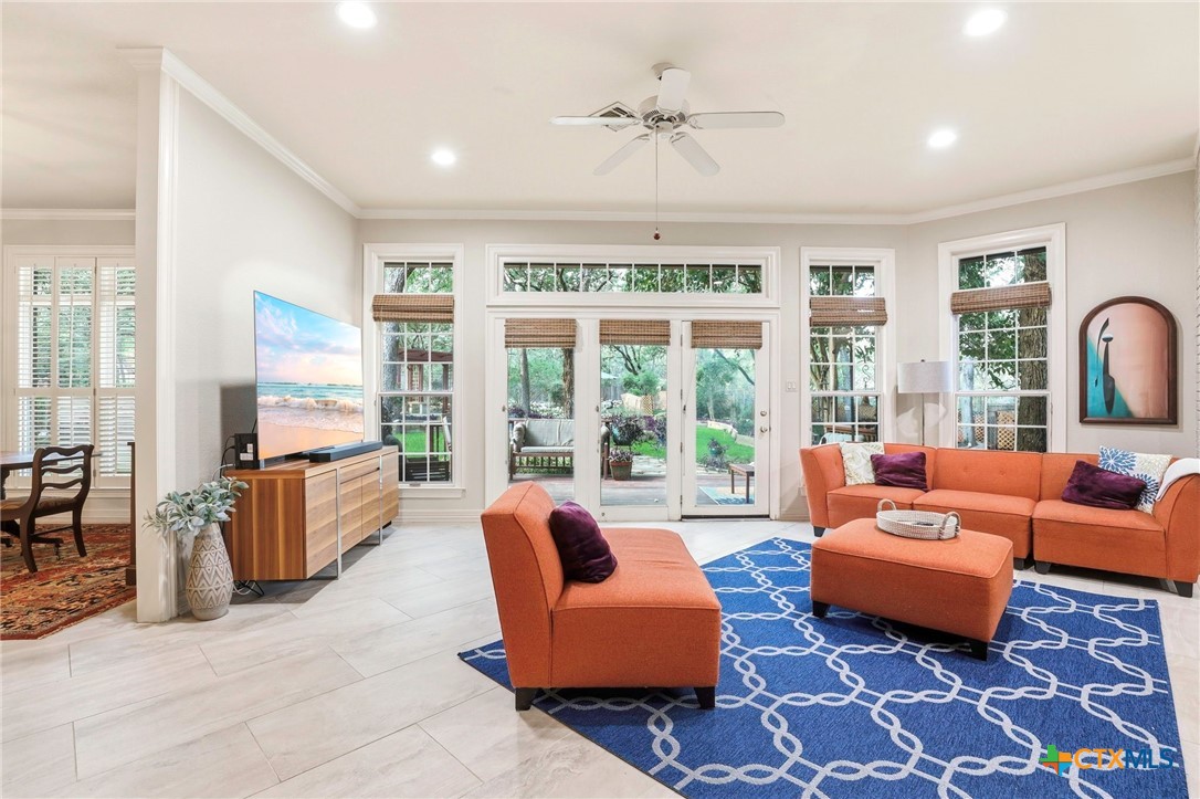 21759 Forest Waters Circle Garden Ridge, TX 78266 - Photo 9 of 30 a living room with furniture and large windows