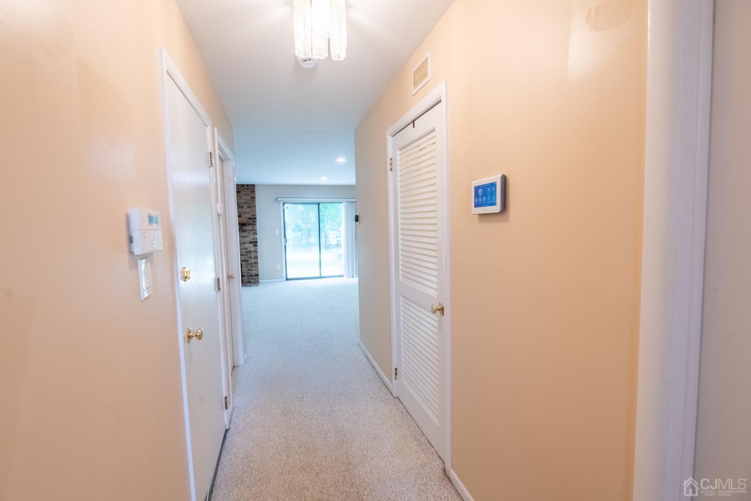 4602 Stonehedge Road Edison, NJ 08820 - Photo 12 of 87 a view of a hallway with wooden floor and staircase