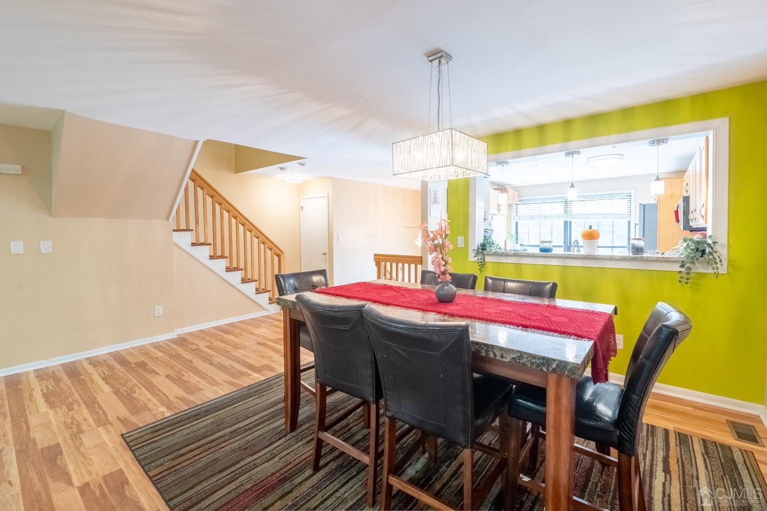 4602 Stonehedge Road Edison, NJ 08820 - Photo 28 of 87 a dining room with furniture a chandelier and wooden floor