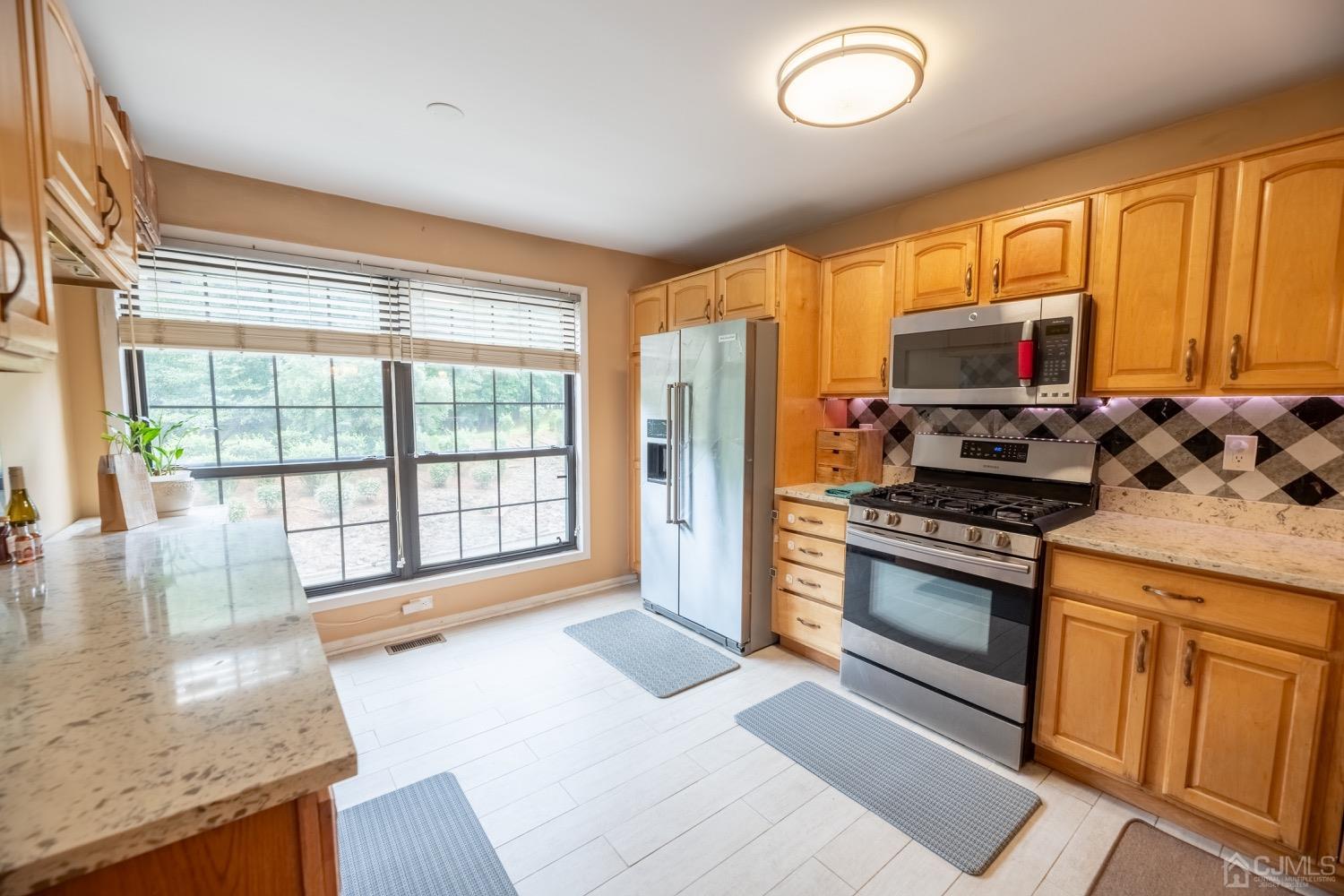 4602 Stonehedge Road Edison, NJ 08820 - Photo 39 of 87 a kitchen with granite countertop a stove and a sink