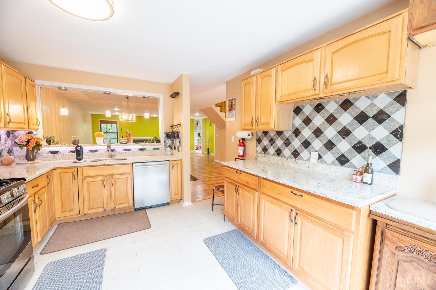 4602 Stonehedge Road Edison, NJ 08820 - Photo 43 of 87 a large kitchen with stainless steel appliances a lot of counter space and a window