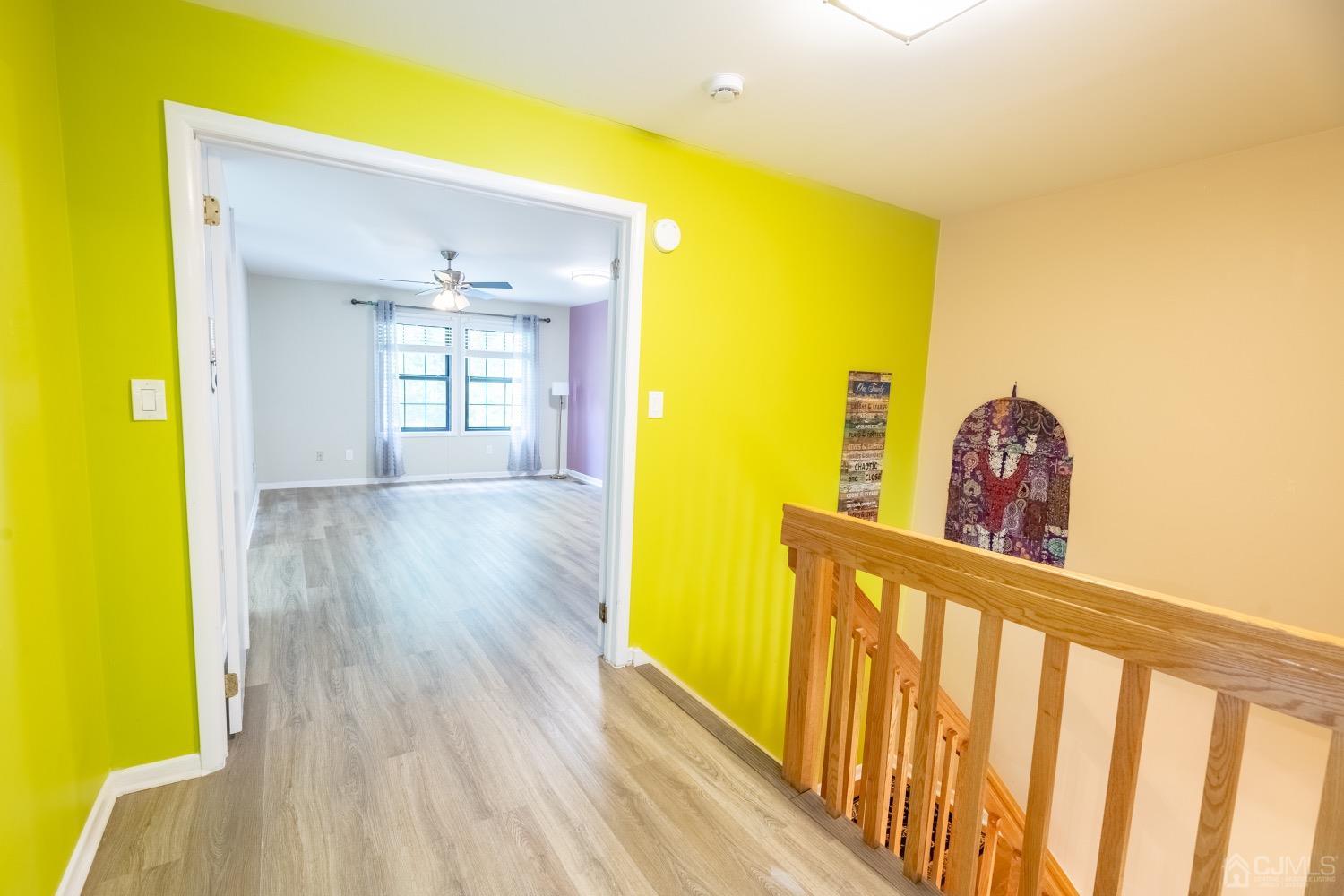 4602 Stonehedge Road Edison, NJ 08820 - Photo 48 of 87 a view of a hallway with wooden floor and a dining room