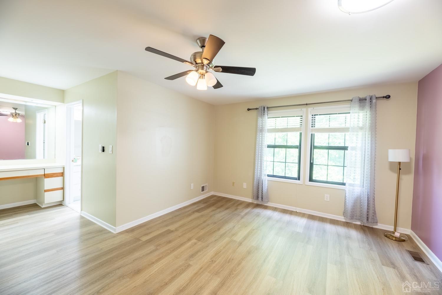 4602 Stonehedge Road Edison, NJ 08820 - Photo 53 of 87 a view of an empty room with window and wooden floor