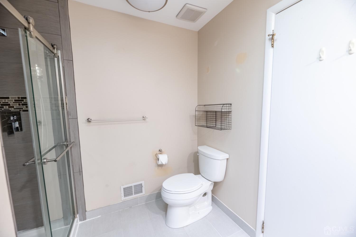 4602 Stonehedge Road Edison, NJ 08820 - Photo 58 of 87 a white toilet sitting next to a bathroom sink