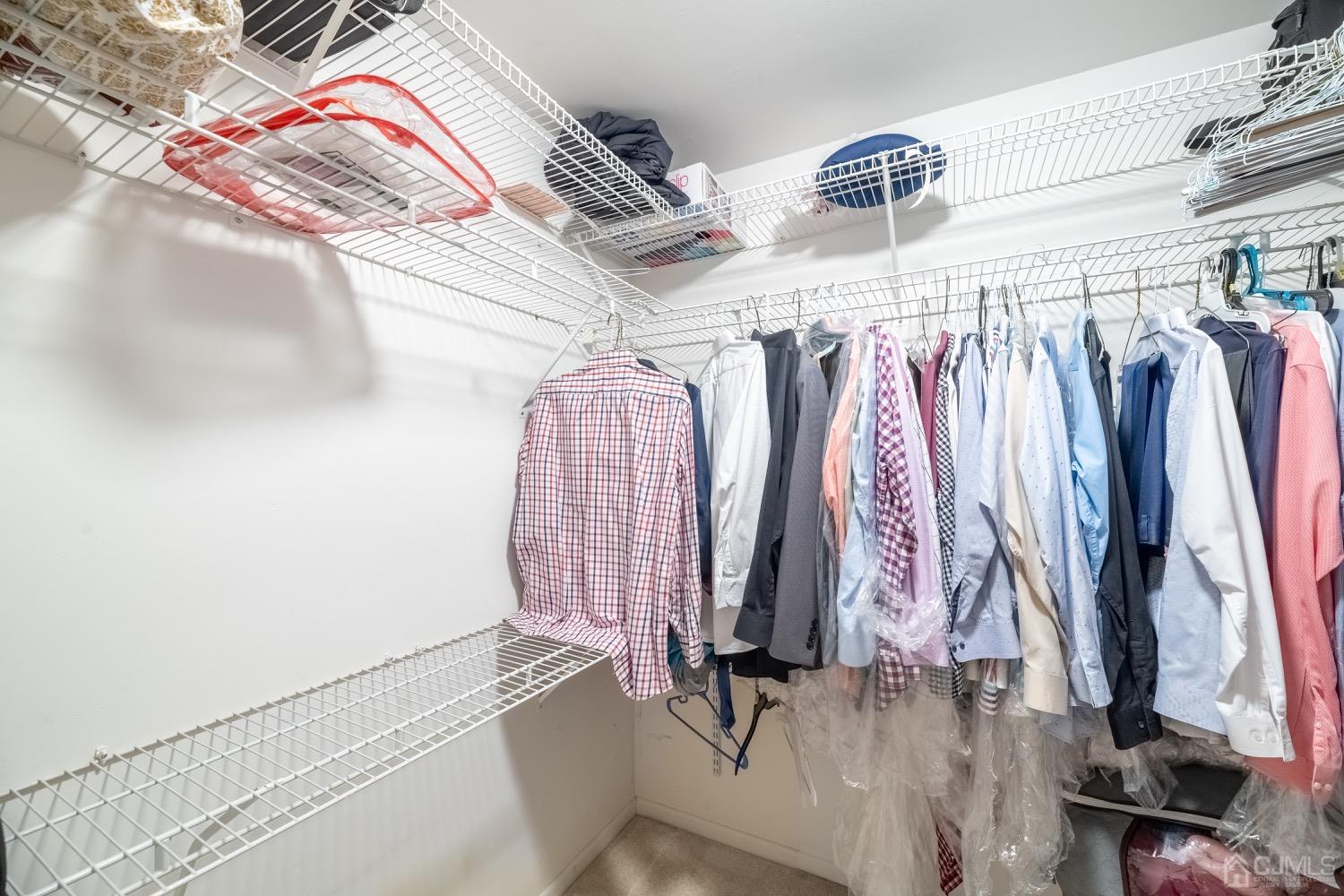4602 Stonehedge Road Edison, NJ 08820 - Photo 59 of 87 a view of walk in closet with clothes and shoes