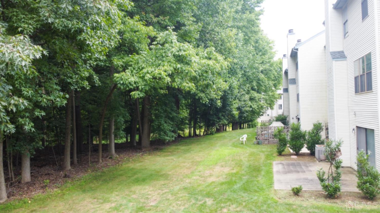4602 Stonehedge Road Edison, NJ 08820 - Photo 81 of 87 a view of a garden with a bench