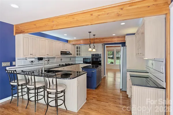 a kitchen with stainless steel appliances a stove a sink dishwasher and a refrigerator