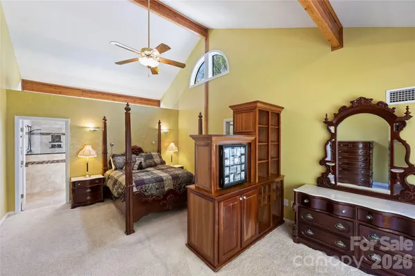 a bedroom with furniture and a mirror