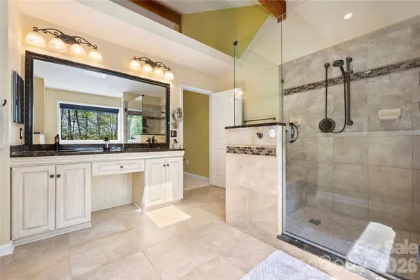 a bathroom with a shower sink and mirror