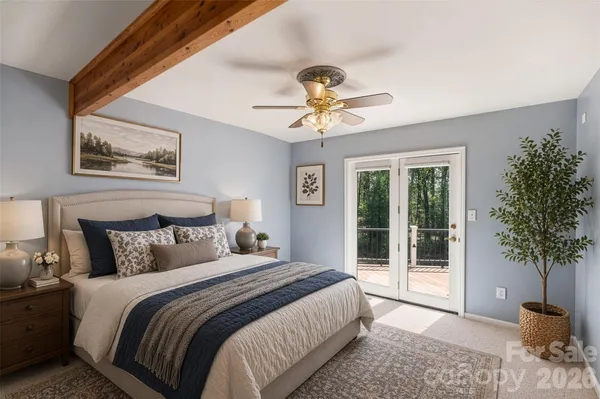 a bedroom with a large bed and a potted plant