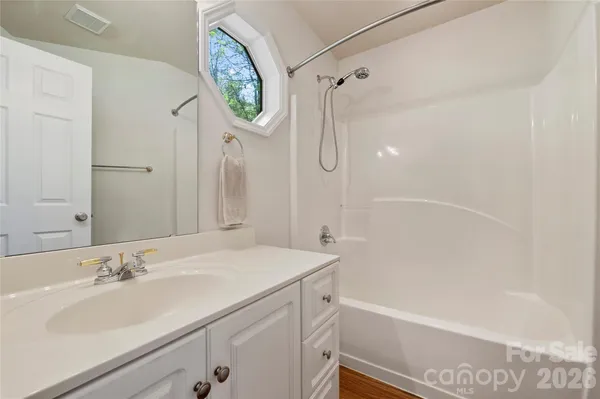 a bathroom with a sink a toilet and a shower