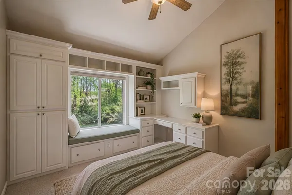 a bedroom with a large bed and a window