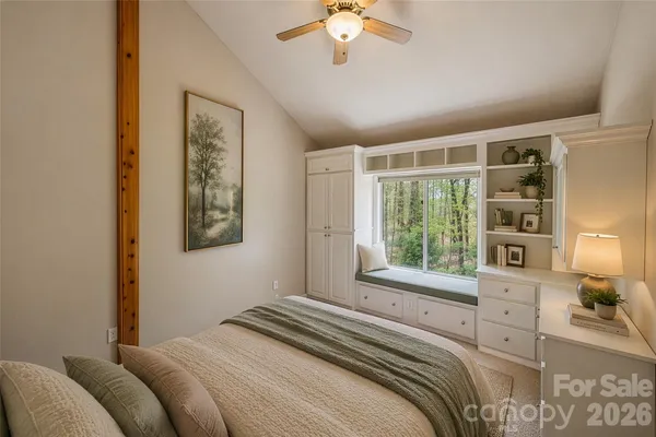 a bedroom with a large bed and a window