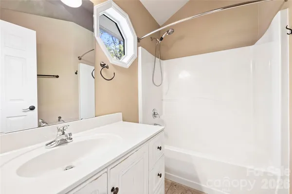 a bathroom with a sink a vanity and a mirror