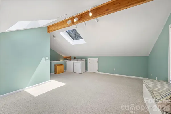 a view of a room with stairs and white walls