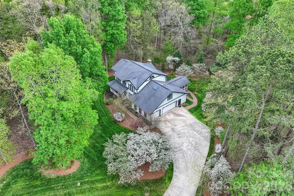 an aerial view of a house with yard and outdoor seating