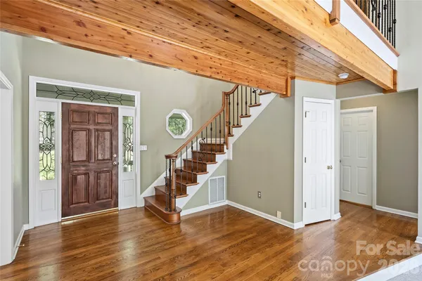 a view of entryway and hall with wooden floor