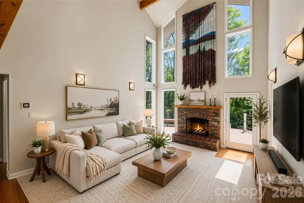 a living room with furniture a fireplace and a flat screen tv