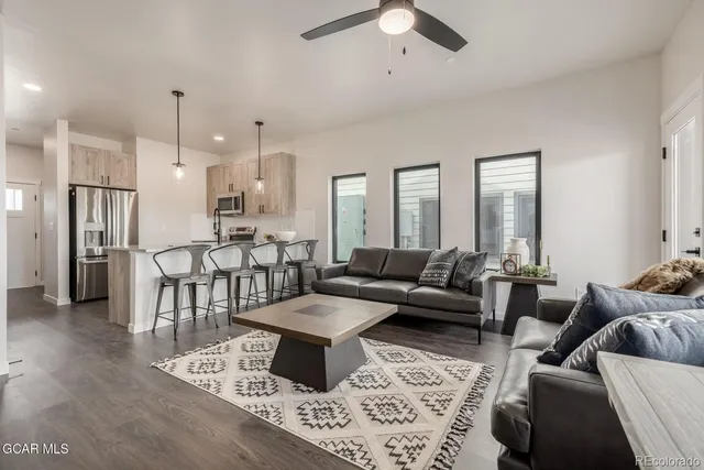 a living room with furniture and a chandelier