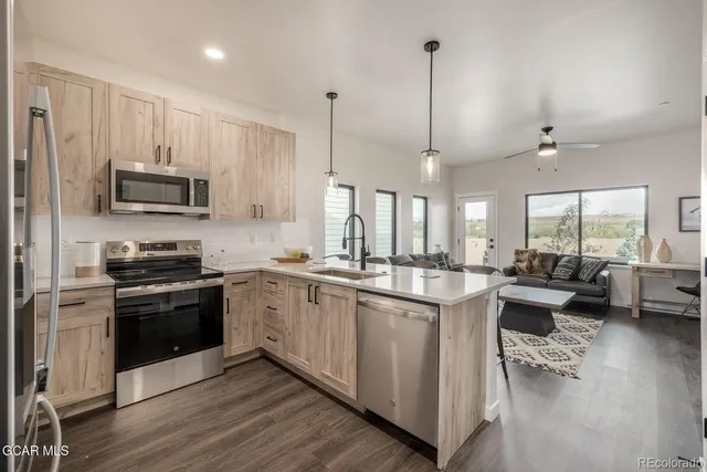 a kitchen with a stove and a wooden floor