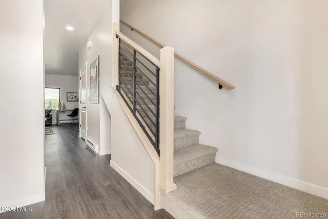 a view of entryway and hall with wooden floor