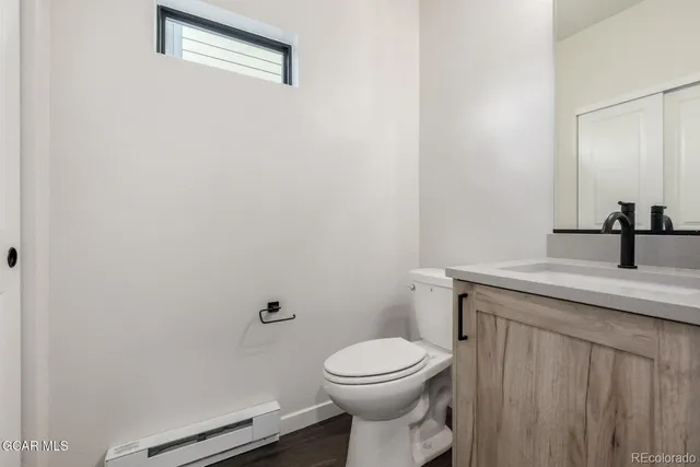 a bathroom with a sink a toilet and mirror